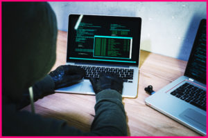 computer hacker using a PC